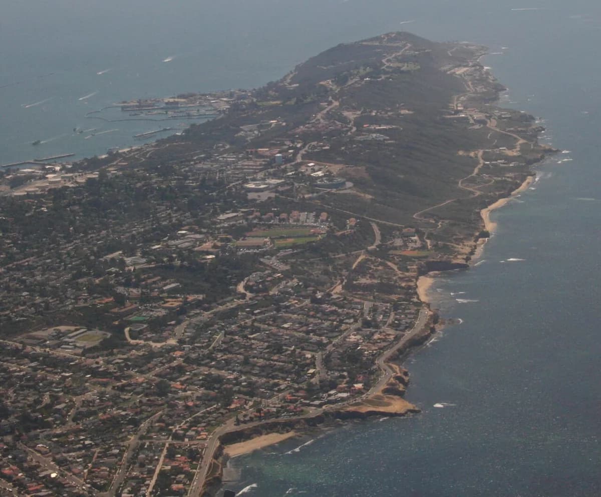An aerial view of the Point Loma peninsula surrounded by water.